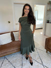 Khaki midi dress with an off-the-shoulder neckline, short sleeves and an asymmetric frilled hem, shown from the front.
