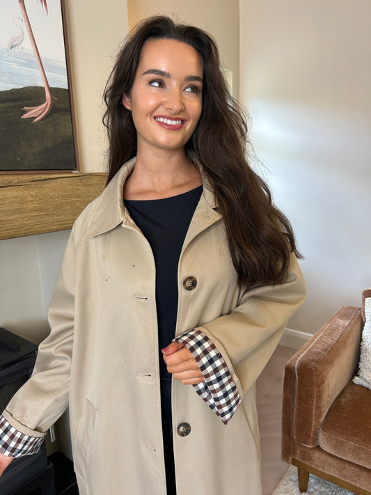Taupe button-front coat with a collar and turned-back check cuffs, shown worn open.